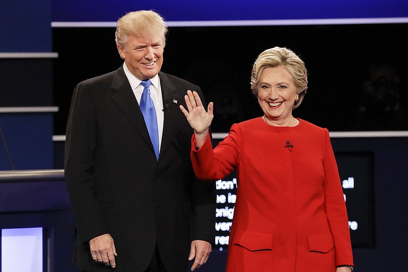 FILE - In this Sept. 26, 2016, file photo, then-Republican presidential nominee Donald Trump and then-Democratic presidential nominee Hillary Clinton are introduced during the presidential debate at Hofstra University in Hempstead, N.Y. Almost 18 months have passed since Clinton lost the presidency. She holds no position of power in government or in her political party. And she is not expected to run for office ever again. Yet Clinton is starring in the Republican Party’s 2018 midterm strategy.  (AP Photo/David Goldman, File)