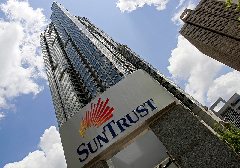 FILE - In this May 7, 2009 file photo, SunTrust headquarters building is shown in Atlanta. SunTrust Banks Inc. says accounts for 1.5 million clients could be compromised following a potential data breach, Friday, April 20, 2018. The Atlanta bank says that it became aware of the potential theft by a former employee and that the investigation is ongoing. Compromised information could include names, addresses, phone numbers and account balances. (AP Photo/John Bazemore, File)