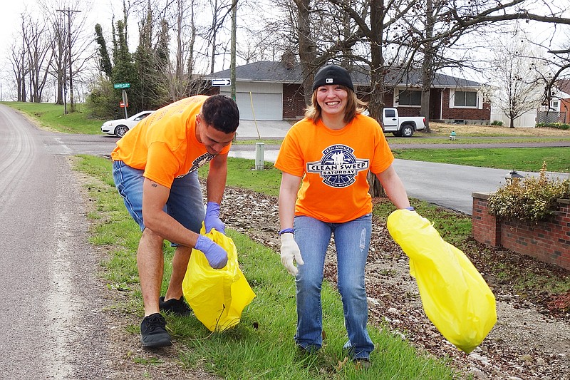 James DeJesus, left, and Lacy McDonald participate in a 2018 Fulton street cleanup event. The county is planning its own cleanup event in April.