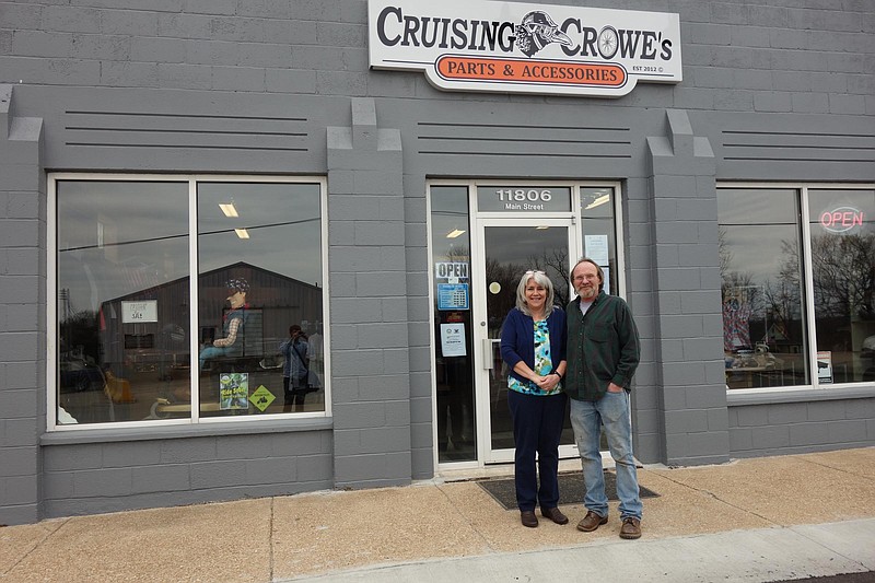 Motorcycle shop owners Theresa Hedrick and Mike Crowe stand before the storefront of Cruising Crowe's Parts and Accessories, a business they hope will help revitalize Centertown.