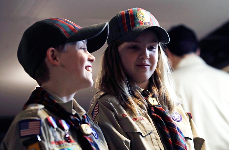 In a Thursday, March 1, 2018 photo, Ian Weir, left, smiles as he stands with his twin sister Tatum after a cub scout meeting in Madbury, N.H. Fifteen communities in New Hampshire are part of an "early adopter" program to allow girls to become Cub Scouts and eventually Boy Scouts. The twins already are planning to become the first set of girl-boy siblings to become Eagle Scouts. (AP Photo/Charles Krupa)