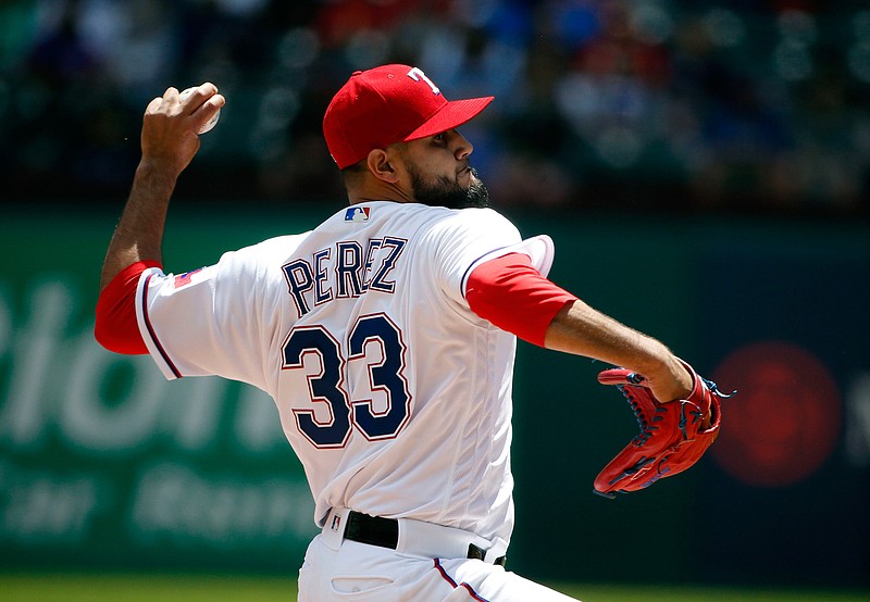 Texas Rangers starting pitcher Martin Perez (33) throws against the Seattle Mariners during the first inning of a baseball game Sunday in Arlington, Texas. 