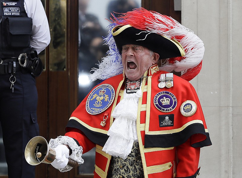 Town Crier Tony Appleton announces that the Duchess of Cambridge has given birth to a baby boy outside the Lindo wing at St Mary's Hospital, Monday, April 23, 2018, in London. Kensington Palace says the Duchess of Cambridge has given birth to her third child, a boy weighing 8 pounds, 7 ounces (3.8 kilograms). (Kirsty Wigglesworth)