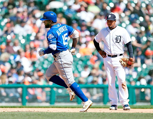 Royals center fielder Abraham Almonte rounds the bases past Tigers third baseman Jeimer Candelario after hitting a grand slam during the sixth inning of Sunday afternoon's game in Detroit.