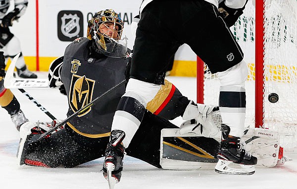 In this April 11 file photo, Golden Knights goaltender Marc-Andre Fleury blocks a shot next to Kings left wing Tanner Pearson during the third period of Game 1 of a first-round playoff series in Las Vegas.