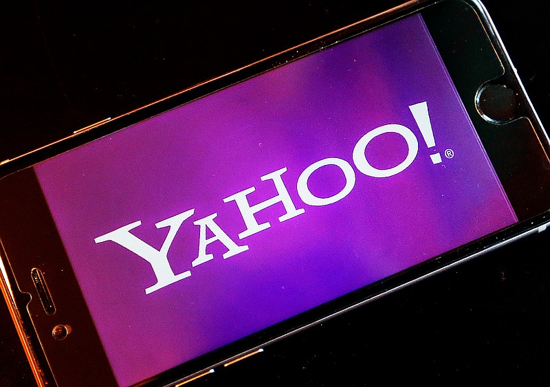 FILE - In this Dec. 15, 2016, file photo, the Yahoo logo appears on a smartphone in Frankfurt, Germany. The company formerly known as Yahoo is paying a $35 million fine to resolve federal regulators' charges that the online pioneer deceived investors by failing to disclose one of the biggest data breaches in internet history. The Securities and Exchange Commission announced the action Tuesday, April 24, 2018, against the company, which is now called Altaba after its most valuable parts were sold to Verizon Communications for $4.48 billion last year.. (AP Photo/Michael Probst, File)