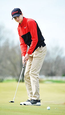 Michael Davidson of Jefferson City watches his putt on the 8th hole Monday in the Capital City Invitational at Meadow Lake Acres Country Club.