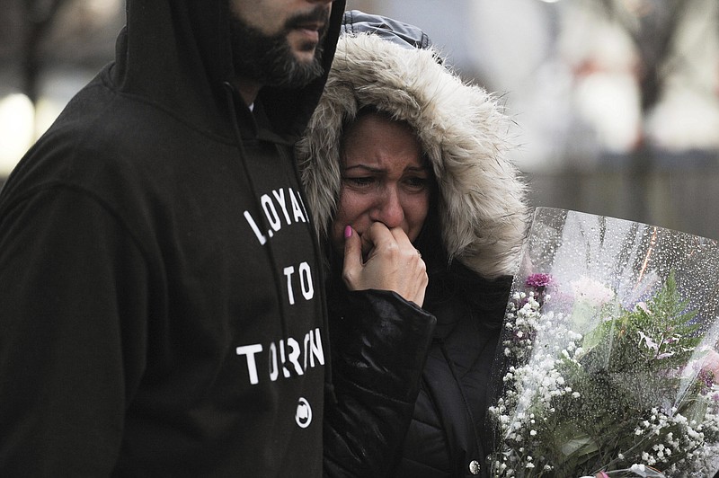 A woman cries at a vigil on Yonge Street in Toronto, Tuesday, April 24, 2018, after multiple people were killed and others injured in Monday's deadly attack in which a van struck pedestrians on a Toronto sidewalk. (Galit Rodan/The Canadian Press via AP)