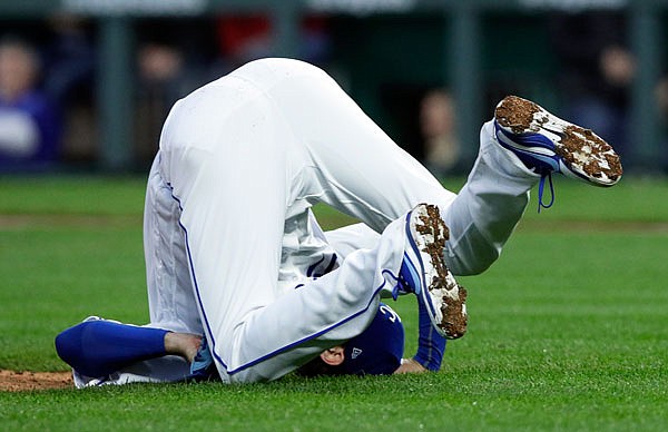 Royals starting pitcher Jason Hammel falls to the ground after getting hit by a batted ball during the third inning of Wednesday night's game against the Brewers at Kauffman Stadium.
