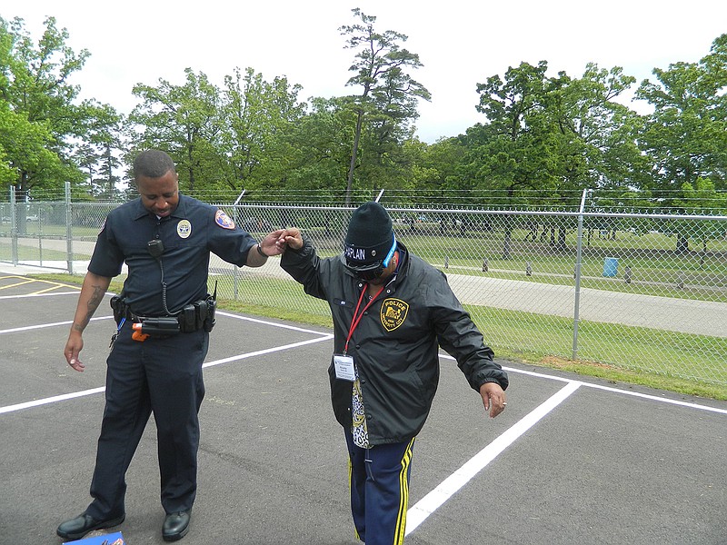  Chaplain Alverta Smith walks a straight line wearing "drunk goggles" with the help of Texarkana, Texas, Police Officer Karey Parker. Smith was one of about 200 police chaplains attending the International Conference of Police Chaplains at the Texarkana, Texas, Convention Center.