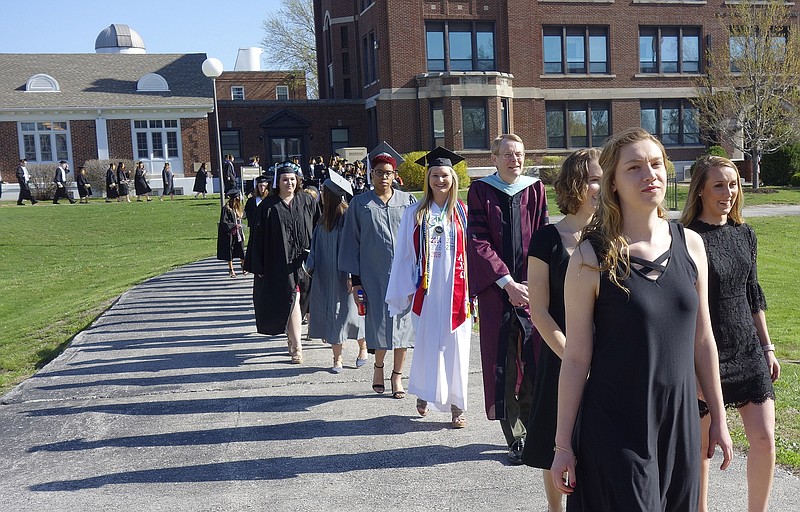 Baylie Borman, white gown, graduating senior class president at William Woods University, leads the 2018 graduation class in Saturday's Ivy Ceremony. She's a Kingdom City resident who majored in business administration with a concentration in marketing.