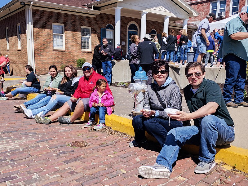 From right, Greg Calvo and Sylvia Calvo along with and Izzy, Fred, Makayla and Chrissy Williams enjoy morels Saturday at Morels and Microbrews. The crowd of festival-goers filled downtown.