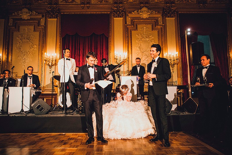 This Jan. 14th, 2017 photo provided by A Taylored Affair shows Bradley Kaplan, left, during a speech at the wedding of Jennifer, sitting, and Parker Taylor in New York. You can plan your wedding down to the tiniest detail. But you can't always be sure what honored guests will stand up and say in toasts and speeches. Some couples get nervous that private stories might be revealed or that religion or politics might cast a pall. (Sasha Israel/A Taylored Affair via AP)