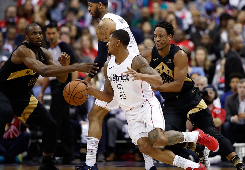 Washington Wizards guard Bradley Beal (3) tries to get away from Toronto Raptors guard DeMar DeRozan, right, during the first half of Game 6 of an NBA basketball first-round playoff series Friday, April 27, 2018, in Washington. (AP Photo/Alex Brandon)