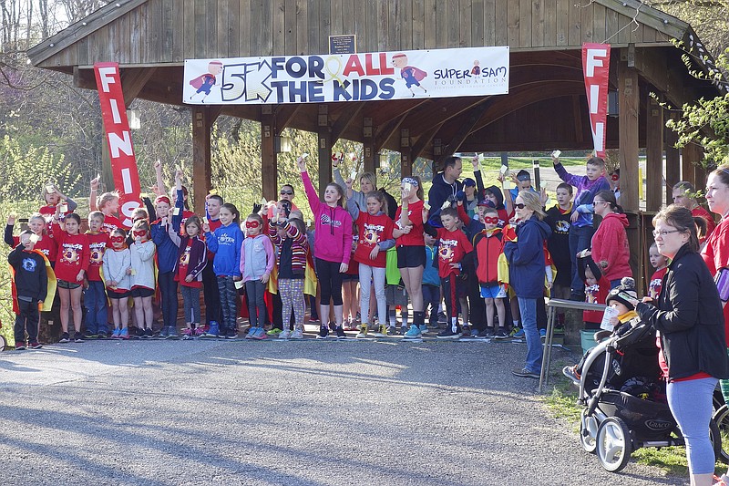 <p>Jenny Gray/FULTON SUN</p><p>Children hold post-it notes aloft at the Super Sam 5K on Saturday. The new, positive endeavor begins today.</p>