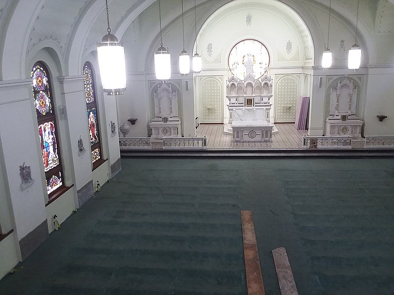 Parishioners work Thursday to remove pews in the sanctuary of St. Edward Catholic Church, above, so restoration of the space can begin. Interior work is the final phase of the project, which will bring the church back to what it looked like when it was built in 1923. Below, the exterior of the church on Beech Street in Texarkana, Ark.