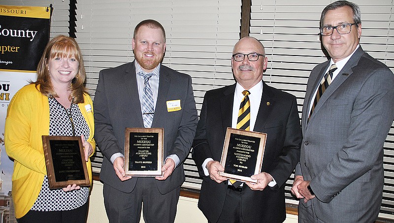 Janet Trowbridge, education awardee; Travis Brinker, agriculture awardee; and Tom Howard, Outstanding Alumnus, display their alumni award plaques while Dr. Christopher Daubert, vice chancellor and dean of the College of Agriculture, Food and Natural Resources at the University of Missouri, looks on.