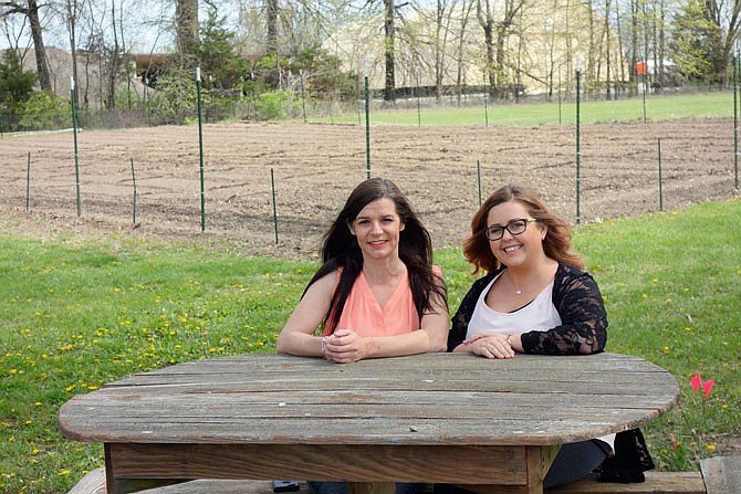 Sitting at a picnic table before a new vegetable garden planted at SERVE, Inc., Keli Tate and Courtney Harrison talked Wednesday about the changes at the Fulton-area nonprofit agency.