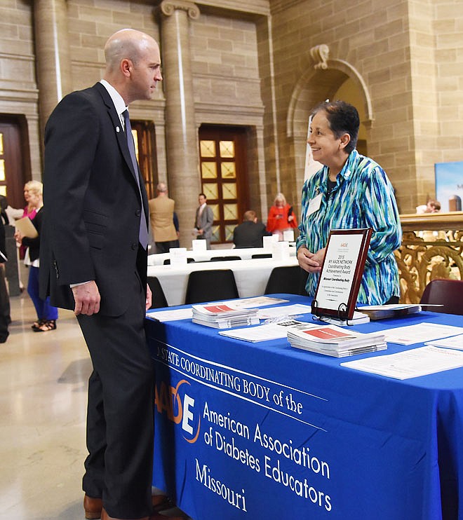 Nancy Trebilcock with the American Association of Diabetes Educators visits with Seth Nieuwenhuis during Wednesday Diabetes Resource Fair in the Capitol Rotunda. She is a registered nurse and certified diabetes educator and talked with Nieuwenhuis, who works for Boehringer-Ingelheim Pharmaceutical about the growing numbers of persons with pre-diabetes and diabetes and how to combat that issue. 