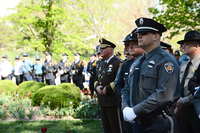 Several law officers from numerous jurisdictions stand at attention Saturday during the Law Enforcement Memorial Service at Carnahan Memorial Gardens. 