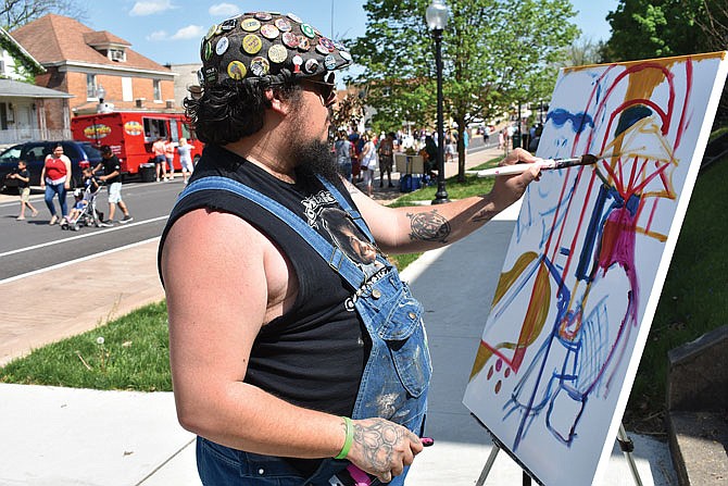 Brandon Province shows his abstract and expressive style of painting Sunday during Porchfest.