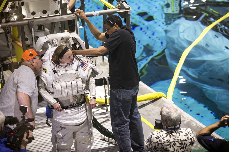 In a Thursday, April 12, 2018 photo, astronaut candidate Zena Cardman gets suited up for training in NASA's neutral buoyancy laboratory, in Houston. Space Center U is a challenging five-day program offered year-round to students so they can experience what training to be an astronaut might be like. (Brett Coomer/Houston Chronicle via AP)