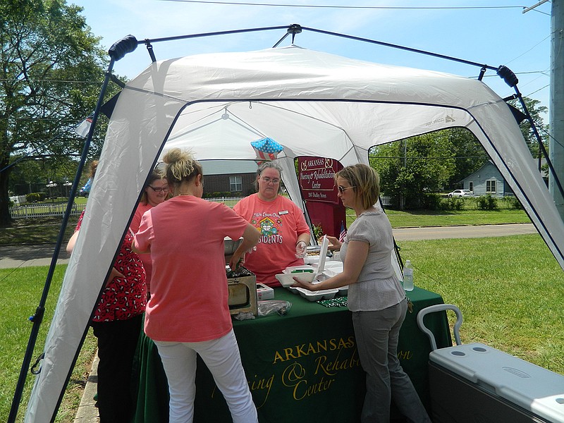 The staff of Arkansas Nursing and Rehabilitation Center prepares lunches Tuesday for local first responders.
