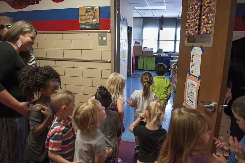Stephanie Sidoti/News Tribune
Children from Mrs. Boyce's class enter the John A. Morris Classroom after the unveiling of the sign dedicating the Southwest Early Childhood Center classroom in memory of John A. Morris on Tuesday, May 15, 2018. The Morris family is sponsoring the classroom of 15 students for five years.