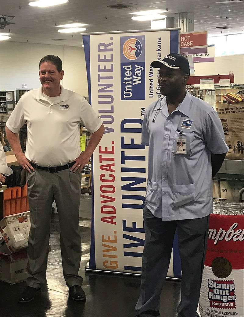 Local postal workers kicked off the National Association of Letter Carriers Food Drive Tuesday at the Oaklawn Post Office. Donated food will be picked up Saturday as postal workers run their routes. Mark Bledsoe, United Way of Greater Texarkana CEO/president, looks on as John Hill, National Association food drive coordinator in this area, talks about the importance of the food drive.