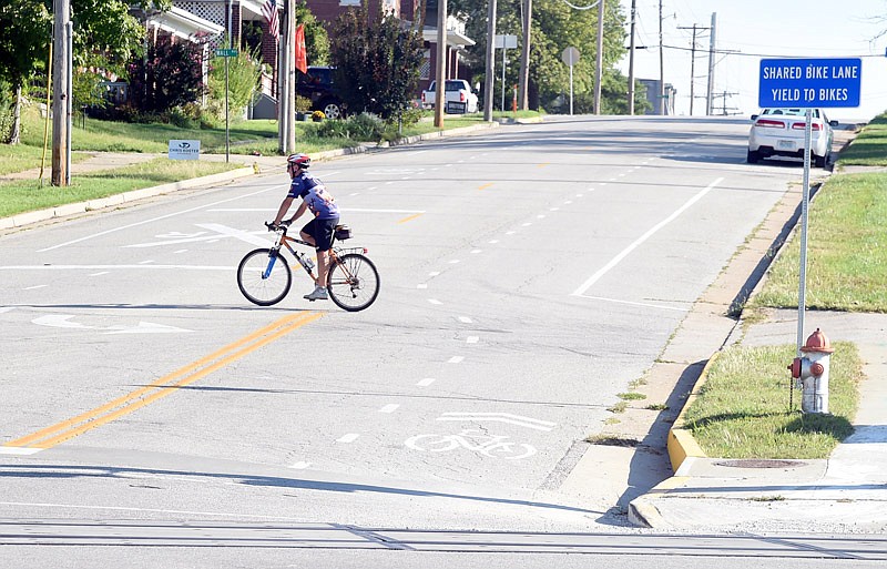 In this Sept. 23, 2016 photo, a bicyclist crosses Jefferson City's Bolivar Street, which is marked with shared bike lanes.
