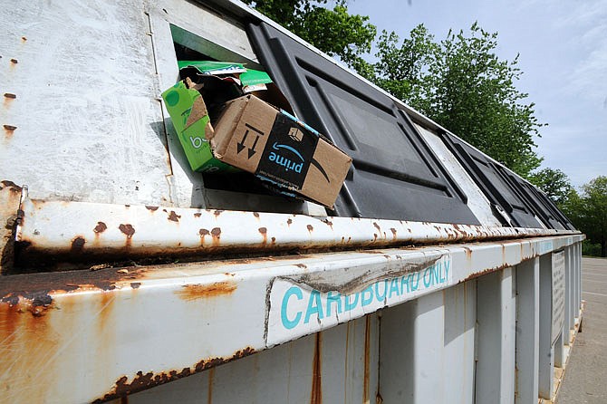 A cardboard recycling bin is filled to the brim Thursday in Memorial Park.