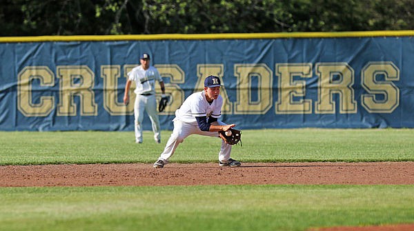 Helias second baseman Parker Schnieders fields a ground ball during Thursday night's game against Sedalia Smith-Cotton at the American Legion Post 5 Sports Complex.