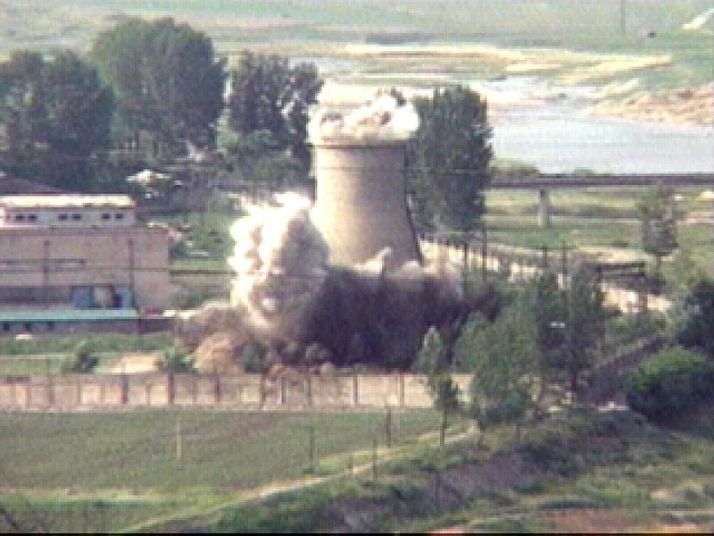 FILE- In this June 27, 2008 file image from TV,  the demolition of the 60-foot-tall cooling tower at its main reactor complex in Yongbyon North Korea.  North Korea's Foreign Ministry said Saturday May 12, 2018, it will hold a "ceremony" for the dismantling of its nuclear test site on May 23-25 in what would be a dramatic but symbolic event to set up the summit meeting between Kim Jong Un and US President Donald Trump scheduled for next month. (AP Photo/APTN, File)