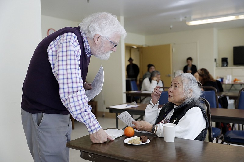 In this Friday, April 13, 2018 photo, Patrick Arbore, left, talks to Corazon Leano as he conducts an anti-bullying class at the On Lok 30th Street Senior Center in San Francisco. Nursing homes, senior centers and other places older adults gather are confronting a problem long thought the domain of the young: Bullying. (AP Photo/Marcio Jose Sanchez)