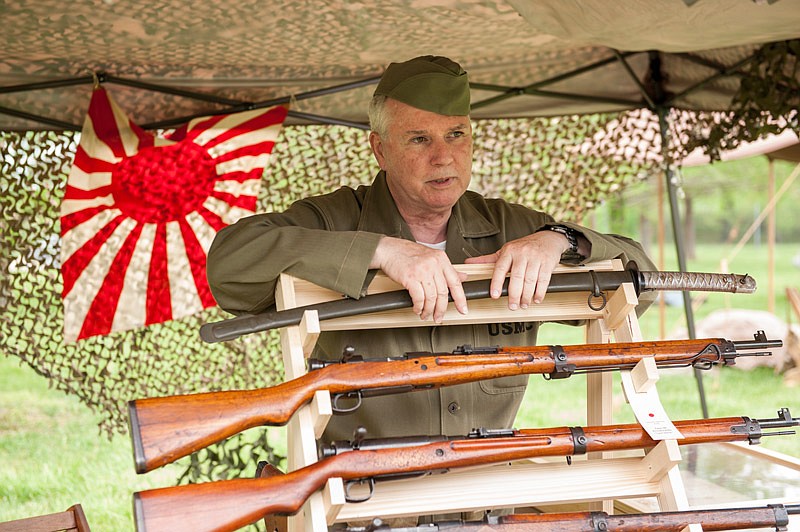 
Rick McClellan speaks about his collection of World War II Imperial Japanese Army field gear, including a factory-made officer's sword at the top of his display, to a visitor during the 4th Annual Missouri Military History Day held at the Museum of Missouri Military History on Saturday, May 12, 2018. McClellan began collecting Japanese field gear about six years ago.