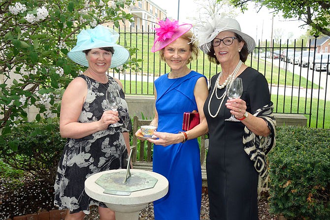 Trying on hats appropriate for a royal wedding from left are Susan Atkinson, Phyllis Fuller and Mary Harrison. They are organizing the National Churchill Museum's reception following the wedding in England of Prince Harry and Meghan Markle.
