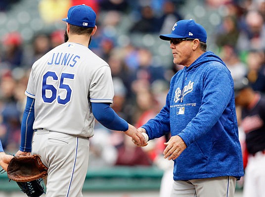 Royals manager Ned Yost takes the ball from starting pitcher Jakob Junis in the sixth inning of Saturday's game against the Indians in Cleveland.