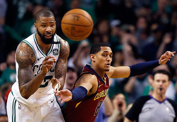 Marcus Morris of the Celtics and Jordan Clarkson of the Cavaliers compete for a loose ball during Sunday's game in Boston.