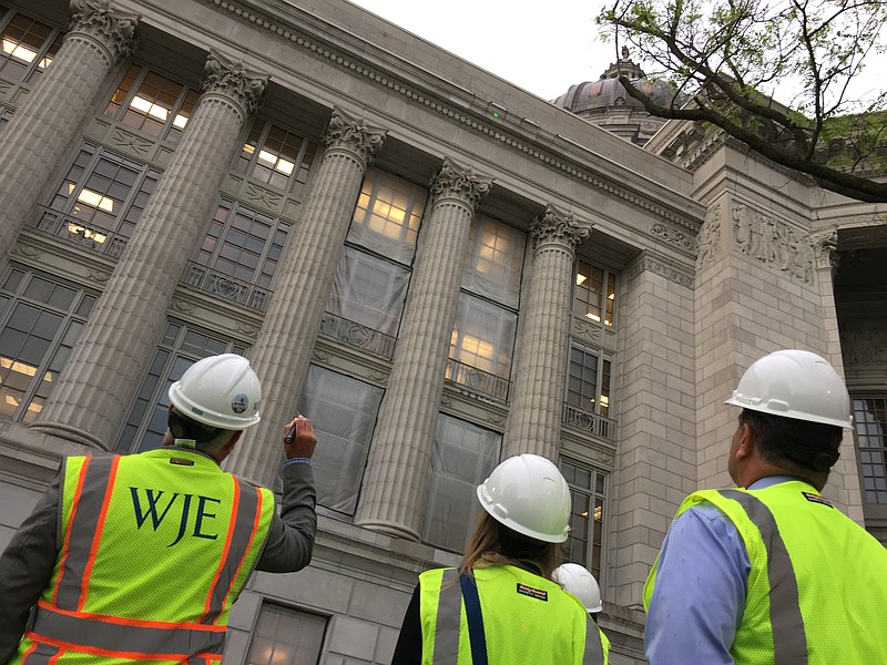 A WJE representative points out a sample of the Phenix Marble to members of the Missouri State Capitol Commission. Restoration crews installed three sample stones in various places on the north side of the Capitol for comparison to the original Carthage stone.