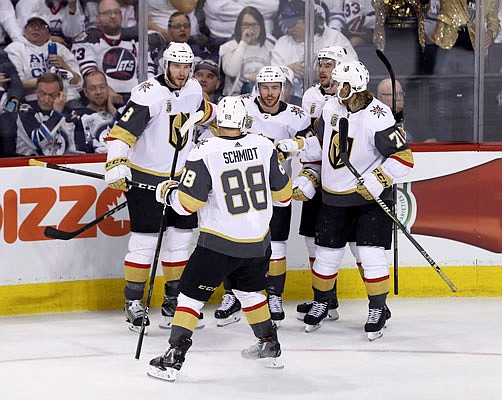 The Vegas Golden Knights' celebrate after Jonathan Marchessault (center) scored during the first period of Monday night's game against the Jets in Winnipeg, Manitoba