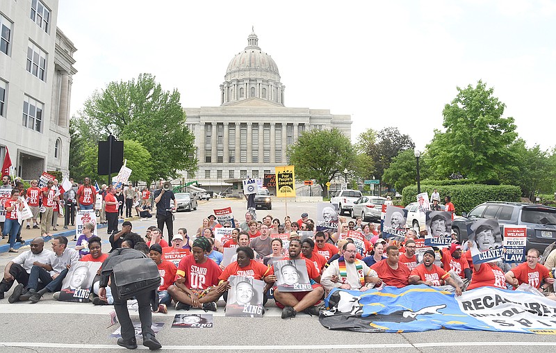 About 200 supporters of the Poor People's Campaign converged on the Capitol grounds Monday for a rally before holding civil disobedient actions, as seen here. After the rally, they marched to the intersection of Capitol Avenue and Jefferson Street for a sit-in as the group demanded to be heard by legislators in the Capitol.