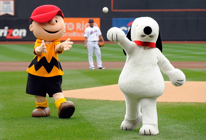 Snoopy throws out the ceremonial first pitch on Oct. 3, 2009, while Charlie Brown looks on prior to the New York Mets playing the Houston Astros in a baseball game at Citi Field in New York. Japanese electronics maker Sony Corp.'s music unit is buying a stake in Peanuts Holdings, the company behind Snoopy and Charlie Brown.