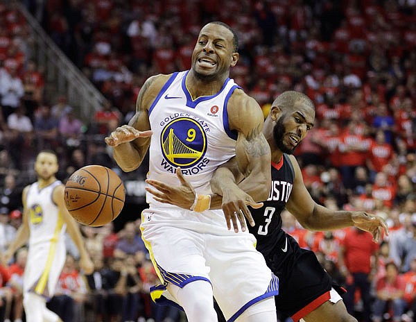 Warriors forward Andre Iguodala is fouled by Rockets guard Chris Paul during the second half Monday in Game 1 of the NBA Western Conference finals in Houston.