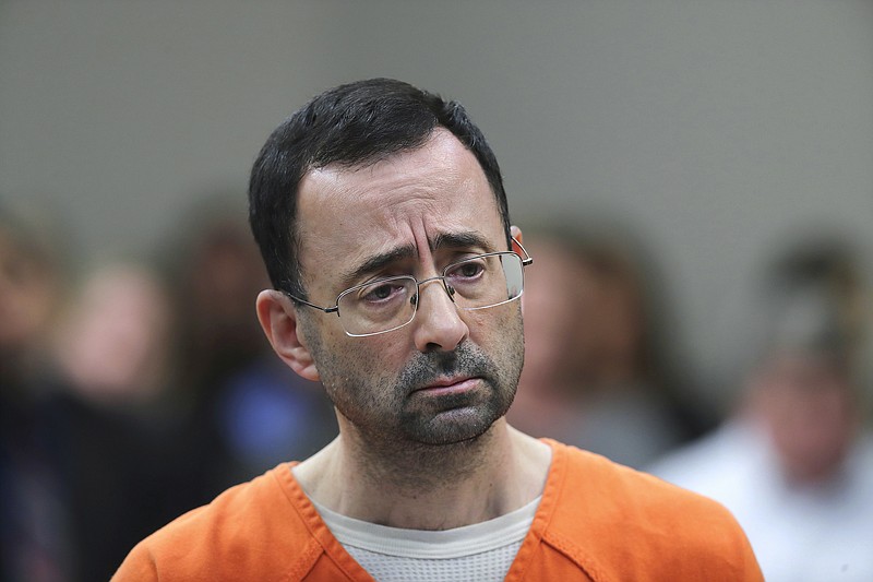 FILE - In this Nov. 22, 2017, file photo, Dr. Larry Nassar appears in court for a plea hearing in Lansing, Mich. Michigan State University has reached a $500 million settlement with hundreds of women and girls who say they were sexually assaulted by Nassar in the worst sex-abuse case in sports history. The deal was announced Wednesday, May 16, 2018, by Michigan State and lawyers for 332 victims. (AP Photo/Paul Sancya, File)