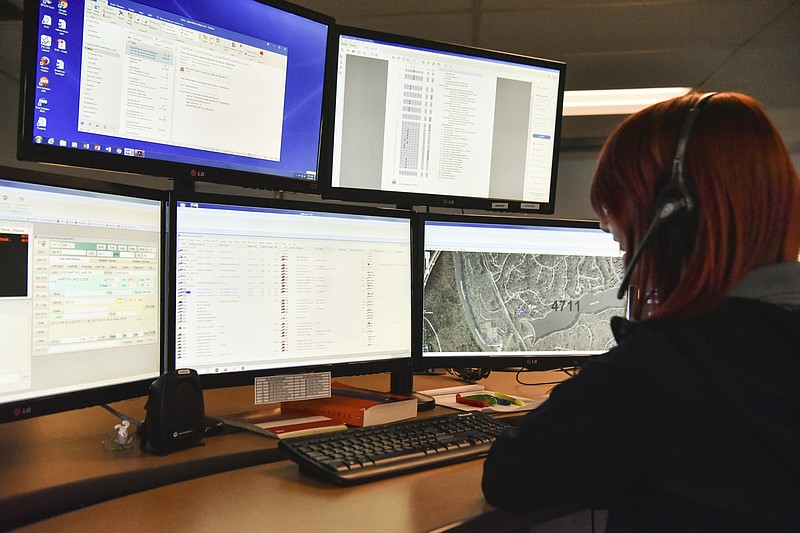 In this photo taken March 15, 2018, a dispatcher in Roswell, Ga., works with a variety of screens while handling a 911 call. The Roswell call center is one of the few in the United States that accepts text messages. This year is the 50th anniversary of the first 911 call placed in the United States and authorities say it is in desperate need to have its technology modernized. (AP Photo/Lisa Marie Pane)