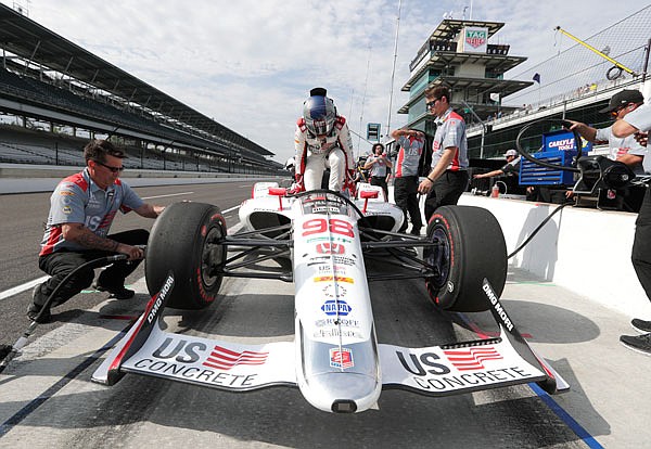 Marco Andretti climbs into his car during Tuesday's practice for the Indianapolis 500 at Indianapolis Motor Speedway in Indianapolis.