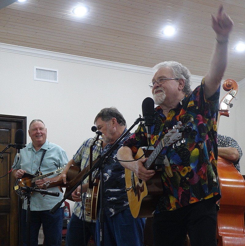  Richard Bowden of Linden, Texas, is having fun Saturday during Laws Chapel United Methodist Church's community music event in Atlanta, Texas. He is with the Hickory Hill bluegrass band, which played for a full house. Ronny Singley of Whitehouse is at left and Don Eaves of Overton is in the middle.