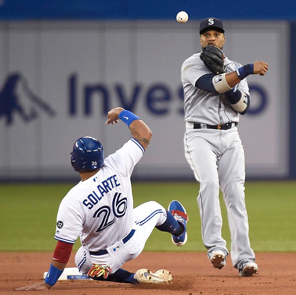 Mariners second baseman Robinson Cano makes the late throw to first base as Yangervis Solarte of the Blue Jays is out at second during the fourth inning of a game last week in Toronto.