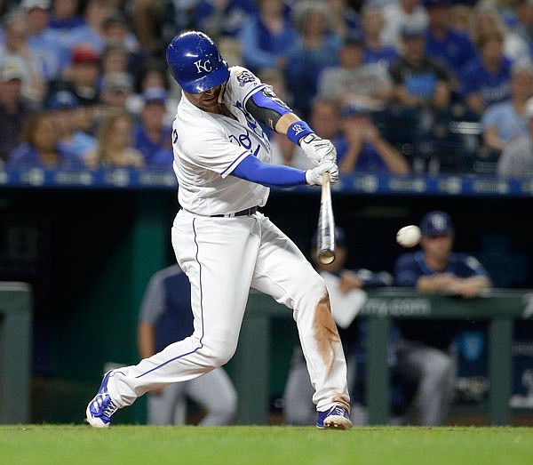 Whit Merrifield of the Royals hits a two-run single during the seventh inning of Tuesday's game against the Rays in Kansas City.