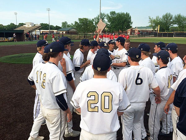 The Helias Crusaders celebrate with the plaque Wednesday after defeating the St. James Tigers in the Class 4 District 9 tournament title game in Sullivan.